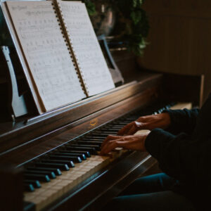 Side view of a pair of hands playing piano