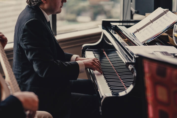 Side view of A man playing on the piano
