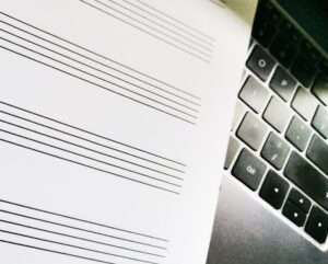 Manuscript paper on a laptop keyboard