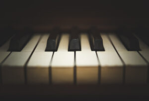 Close-up view of keys on an antique, wooden, upright piano.